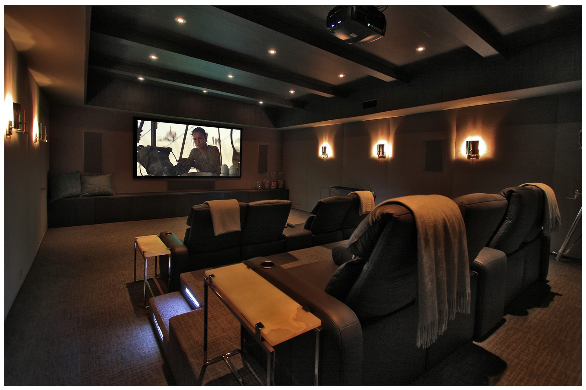 THEATER IN A DEDICATED ROOMThe before and after picture illustrate how two interconnected rooms in a finished basement were joined and subsequently turned into a dedicated basement theater.Special treatment of the ceiling limited intrusion of sound into upper floor. Theater features JBL Synthesis audio elements and a Digital Projections projector.