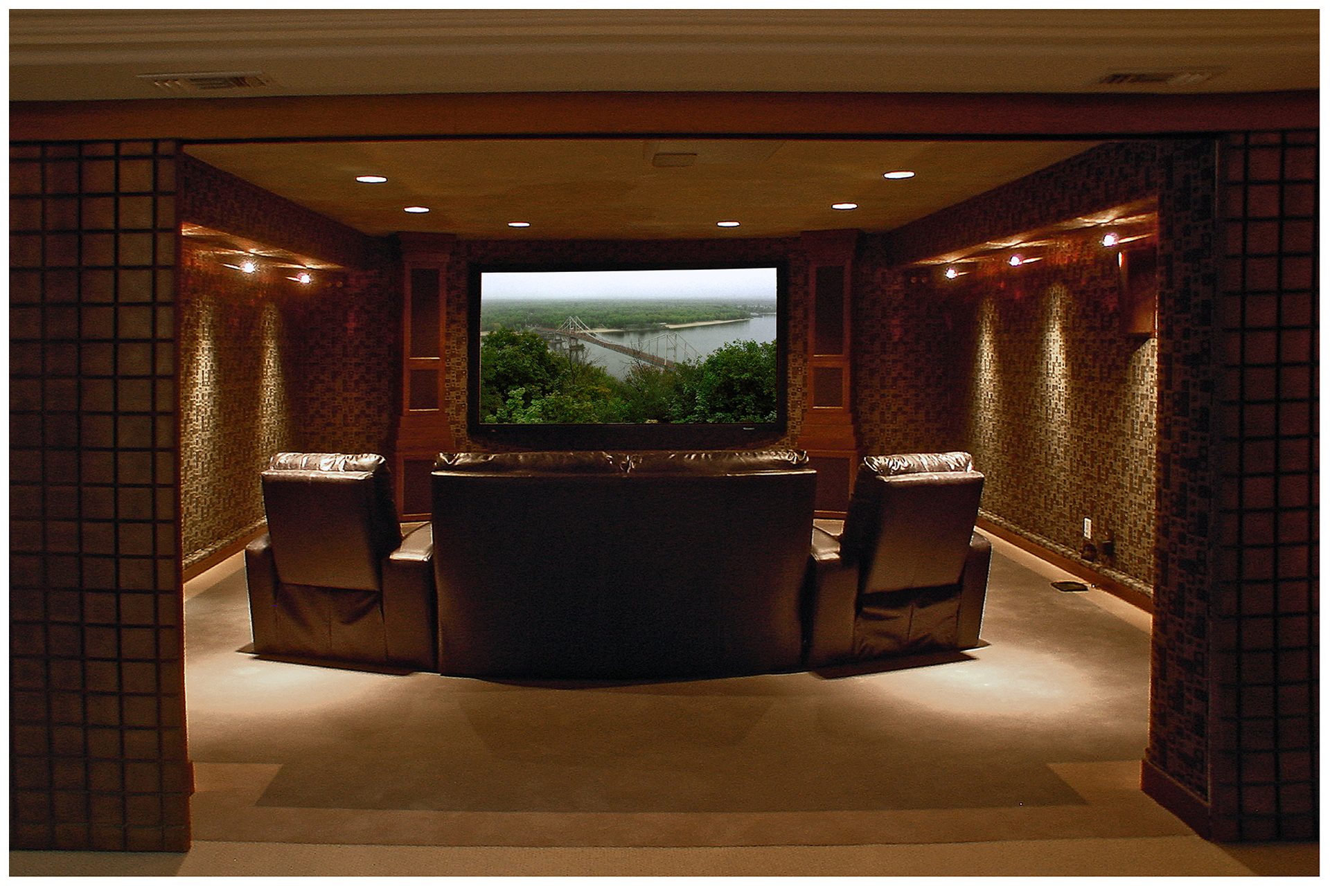 SMALL THEATER IN A DEDICATED ROOMThe before and after pictures above illustrate transformation of a relatively small spare storage space in a basement into a high-end small theater.  Room's ceiling height of only eight feet limited seating to only one row. The four-seat theater however suited well the family of three.