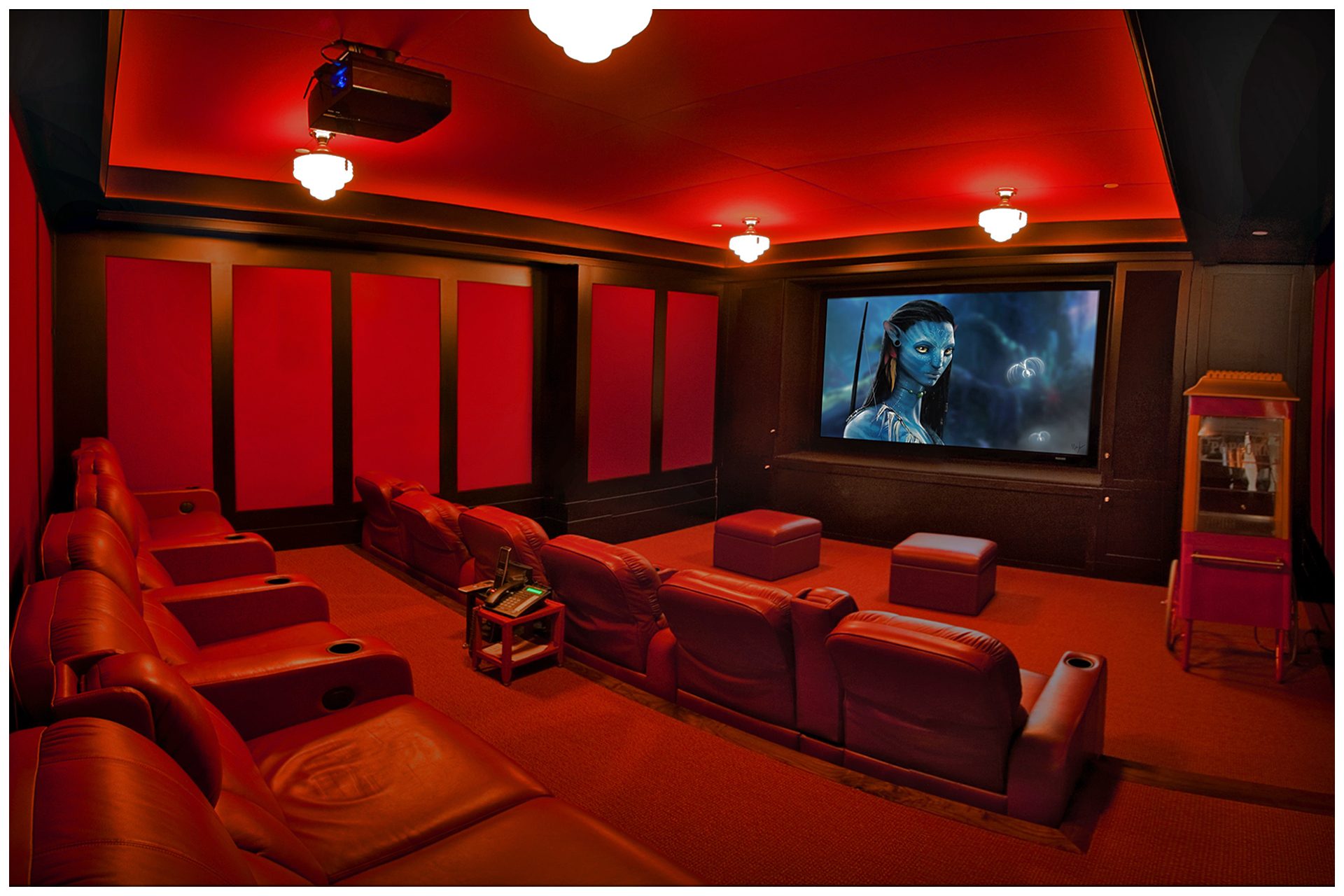 DEDICATED BASEMENT THEATER 12 seat dedicated basement theater with Acoustic paneling to limit sound intrusion outside the room. Front Speaker elements are enclosed into cabinetry and all other  speakers are placed under acoustical panels.Screen and seating are placed on the right side of the room to allow a wide isle leading to exit door in so doing, seats in the center are centered on the screen and front speakers.System is enclosed in an adjacent closet.