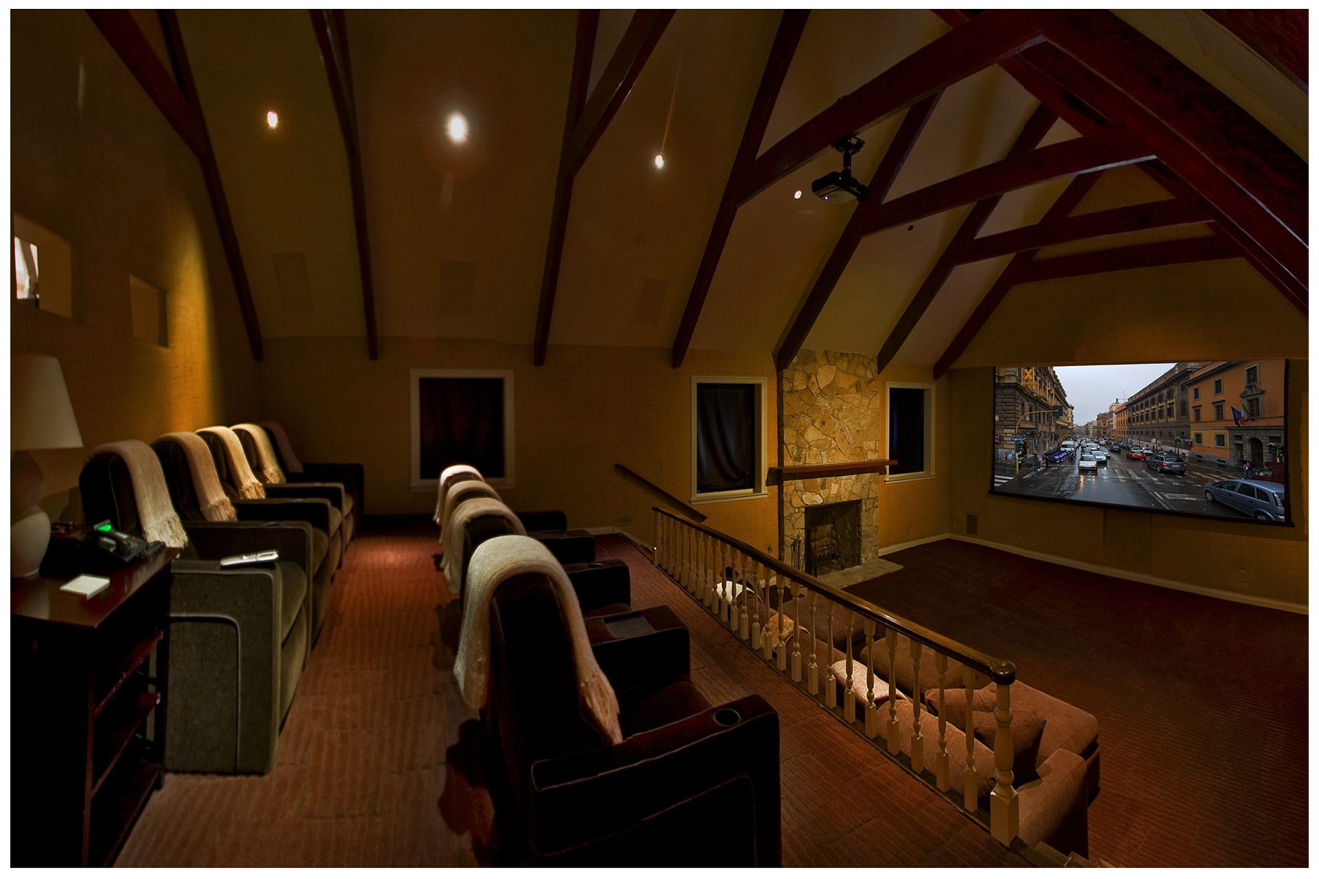 DEDICATED LARGE THEATER The screening room in this large theater was fitted with both a 35mm projection system and later on with a video projector system. Shades were installed to darken the room for daytime viewing. This theater designed for a large family featured 14 seats. A Crestron touch panel offered complete control of all AV and lighting. Theater features JBL Synthesis audio elements and a Digital Projections projector.