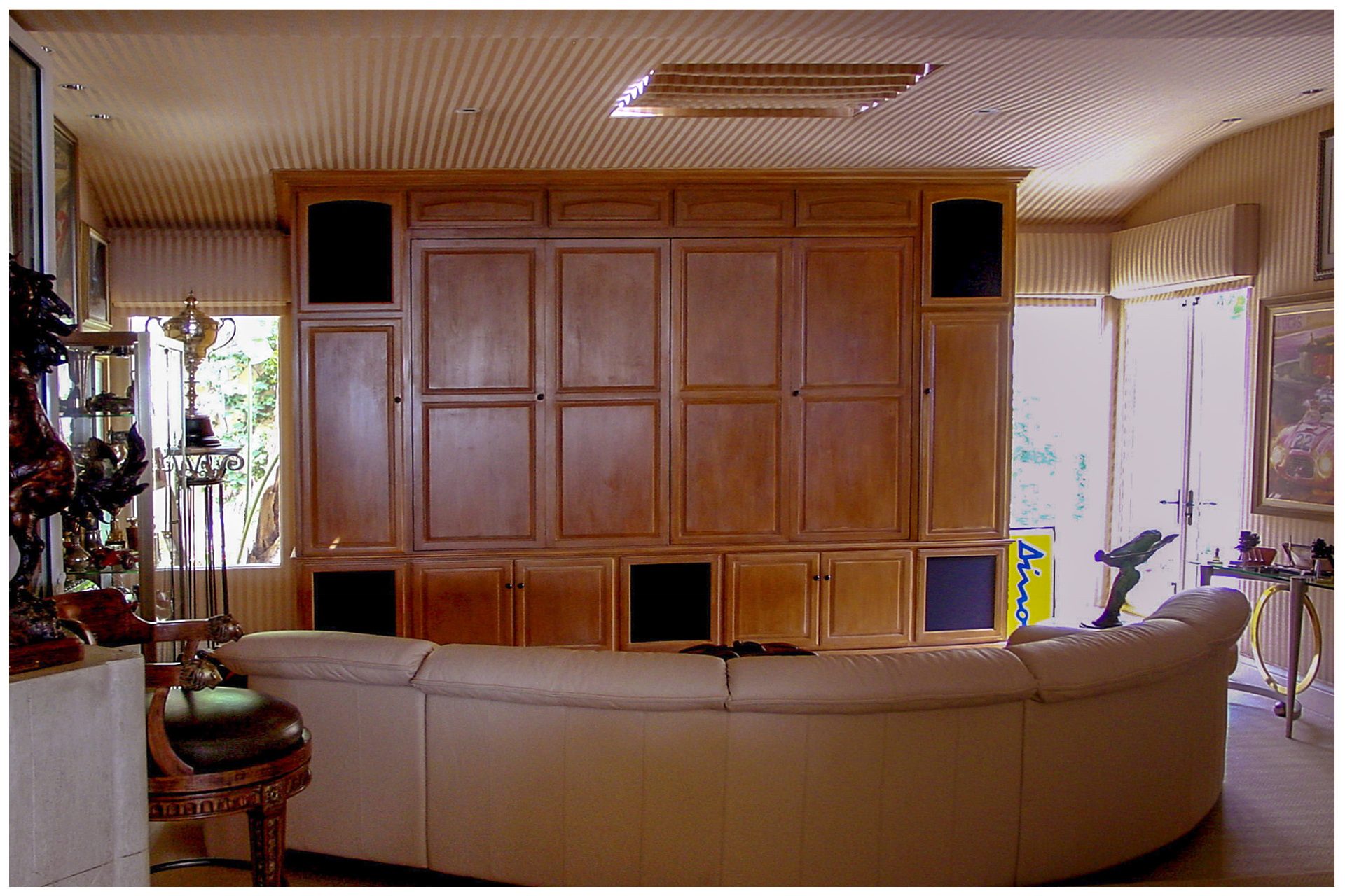 SMALL DEN THEATER All speaker elements were enclosed in the cabinet.  The projector was recessed into the ceiling.The cabinet was designed with space and wiring provisions to accommodate a future upgrade to a large LED screen behind a drop down screen for daytime viewing.